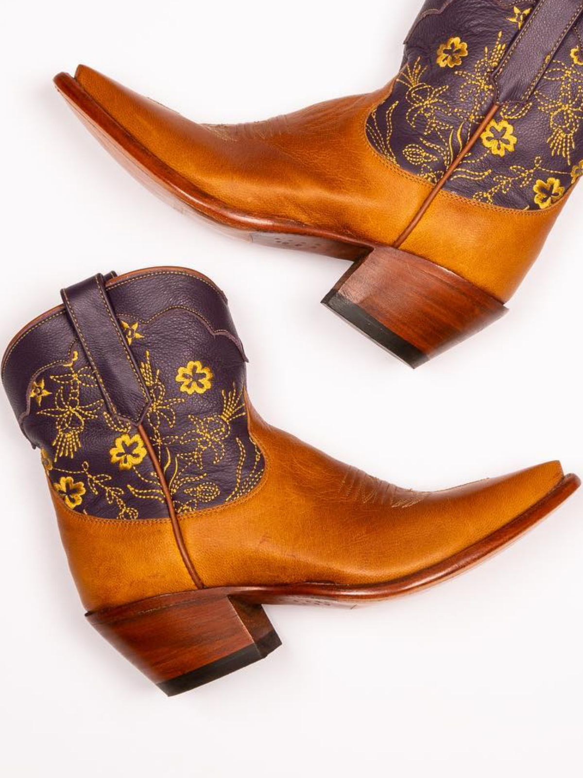 Contrast Tawny And Black Snip-Toe Cowgirl Ankle Booties With Floral Embroidery