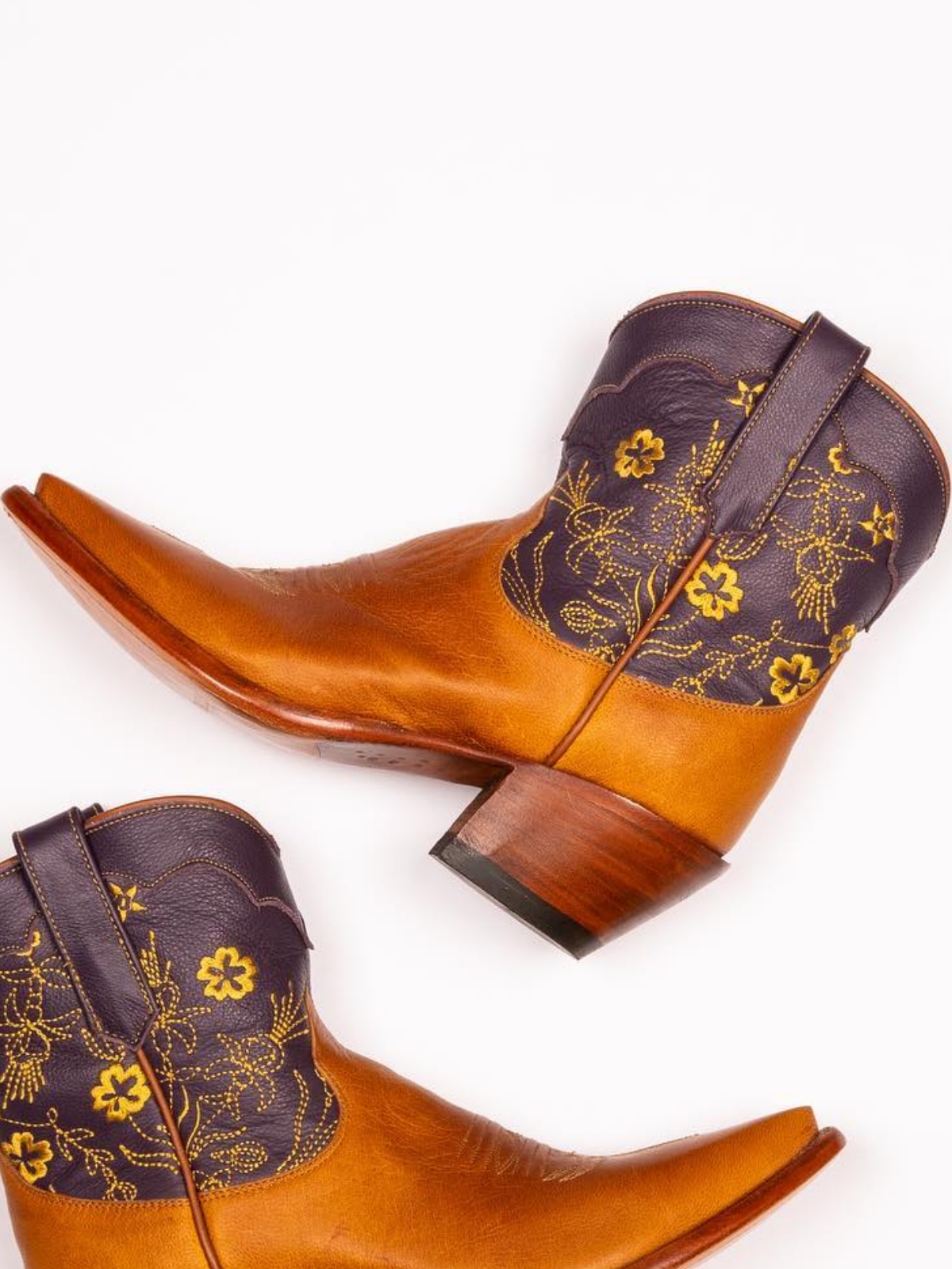 Contrast Tawny And Black Snip-Toe Cowgirl Ankle Booties With Floral Embroidery